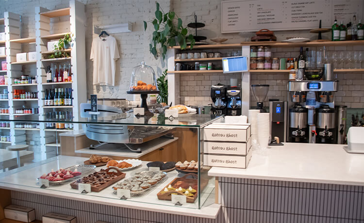 View of the front counter of Gateau Ghost, with coffee brewing and pastries on display.