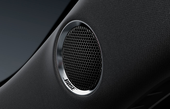 Close-up of embedded Bose speaker with Bose logo.
