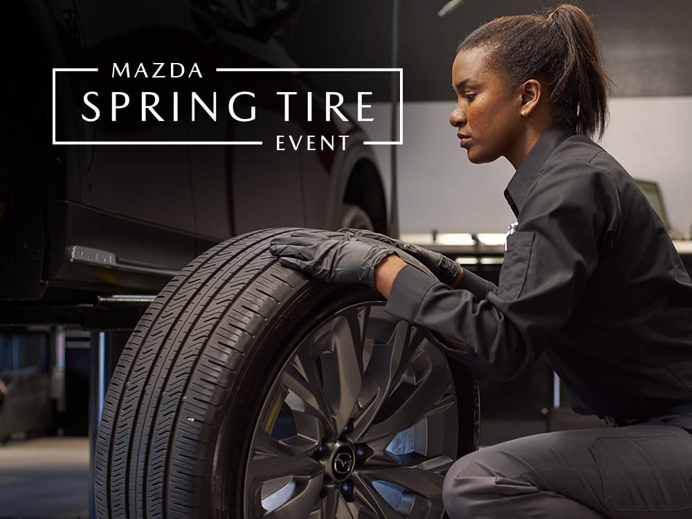 A Mazda technician changing the tires on a vehicle