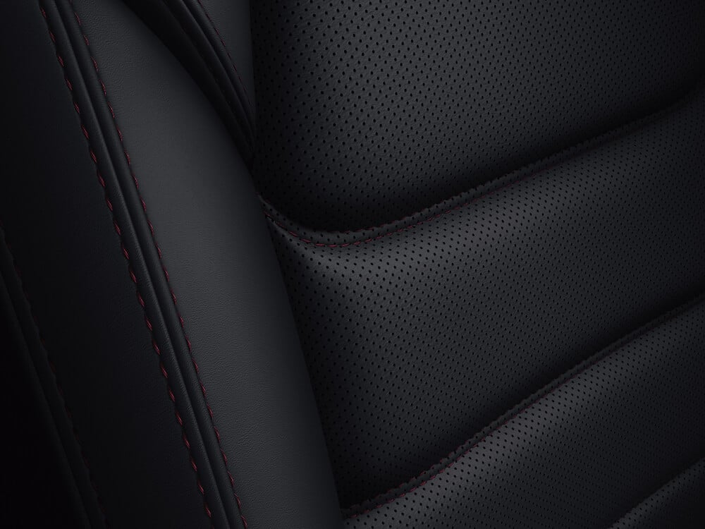 Black leather-trimmed upholstery with red stitching. 