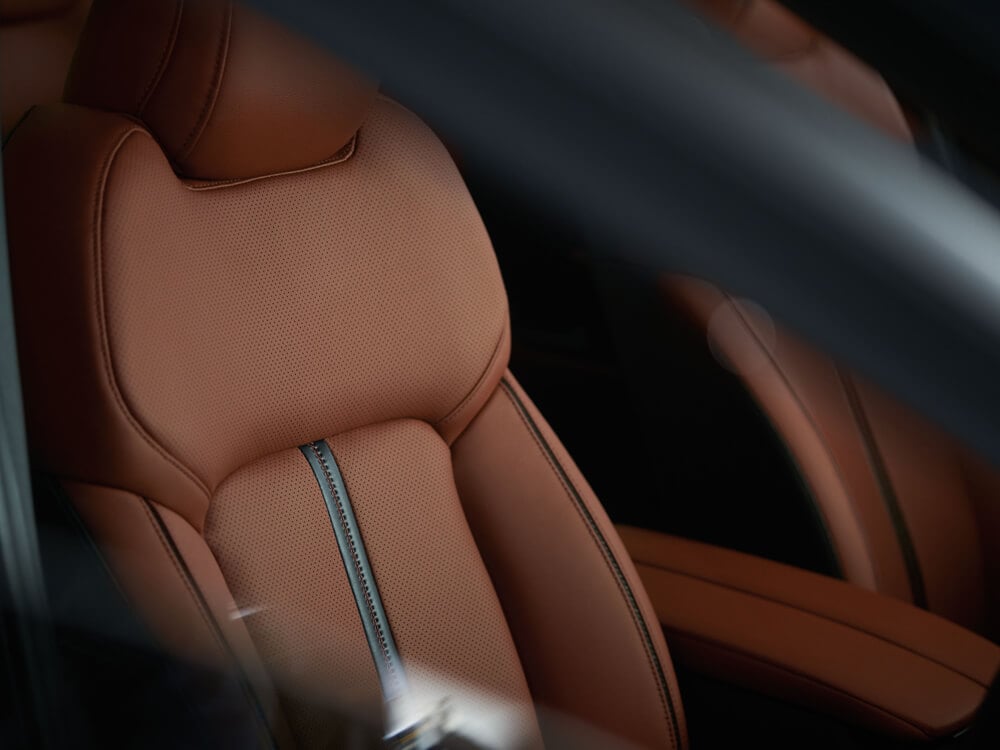 Closeup of Terracotta Leather seat showcasing stitching and details.  