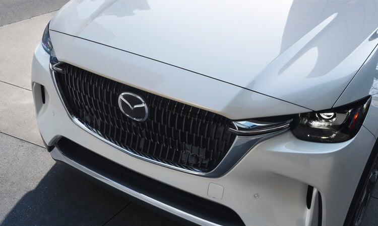 Close-up of Arctic white CX-90 front grille