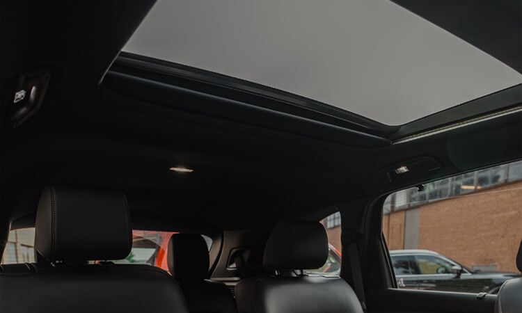 Looking up at the roof from inside the CX-90 showing the spanning Panoramic Moonroof.