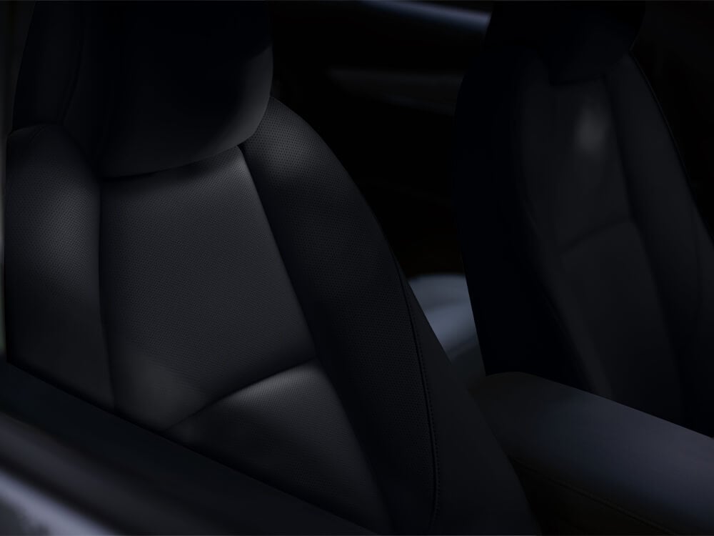 Close-up of material and perforated detail on front seats of Mazda3 Sedan. 
