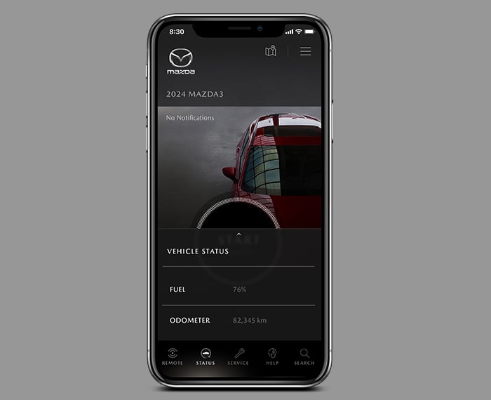 Smartphone with MyMazda app on Vehicle Status screen.