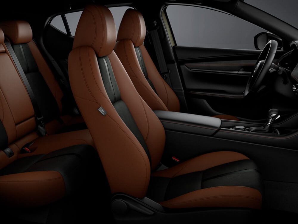 Terracotta/Black Leatherette interior, front seats and partial back seats of Mazda3 Sport Suna Edition.
