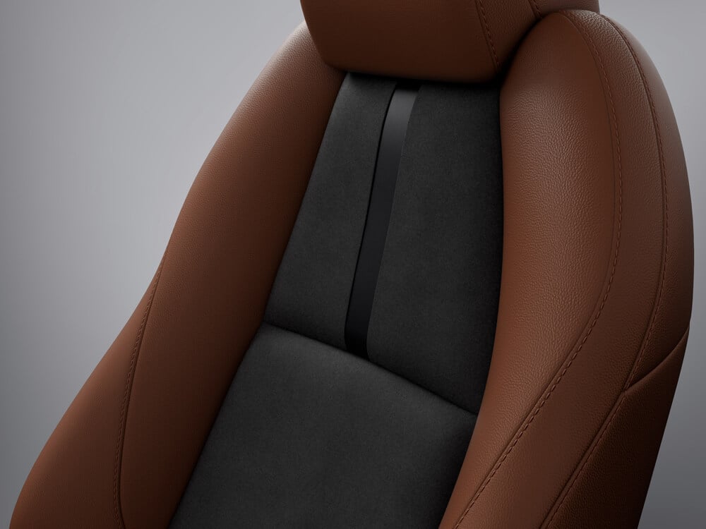 In studio, not situ, close-up of materials and detail on Terracotta/Black Leatherette seat of Mazda3 Sport Suna Edition.