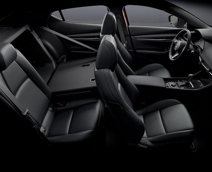 From above passenger side, full Mazda3 Sport cockpit, one of the back seats is down showing access to hatch cargo area.  