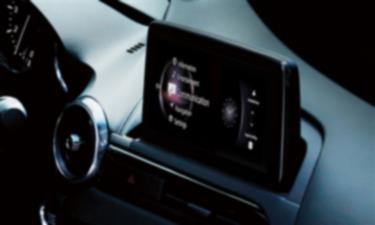 Interior view of the MX-5 RF dashboard with the touchscreen interface displaying a variety of apps. 