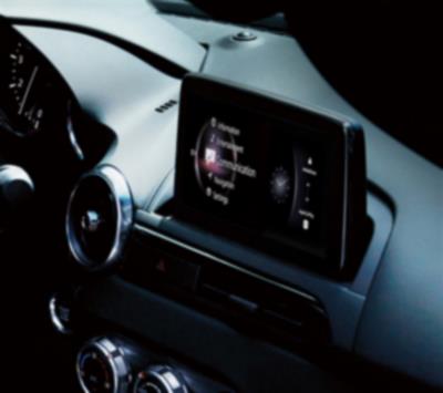 Interior view of the MX-5 RF dashboard with the touchscreen interface displaying a variety of apps. 