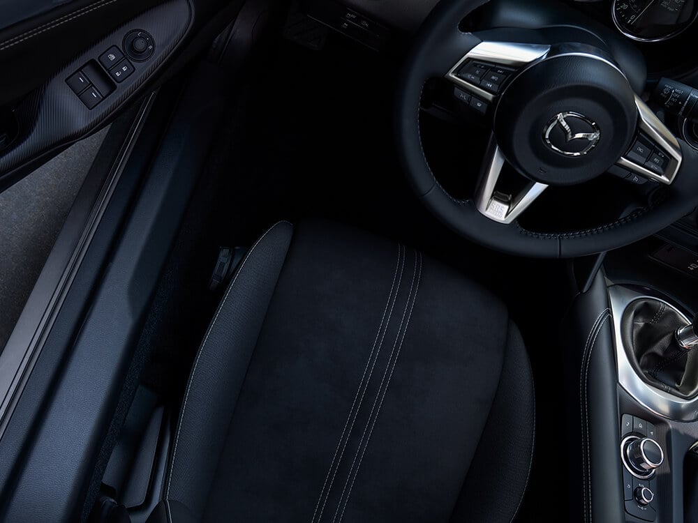 Close-up view of the interior of an MX-5 RF with seat and steering wheel visible.