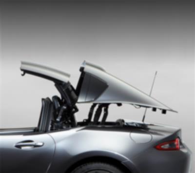 Image of a silver MX-5 RF hard top in the process of being retracted.